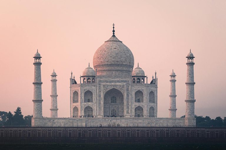 Beautiful view of the Taj Mahal at sunrise, showcasing its stunning architecture and historical significance.