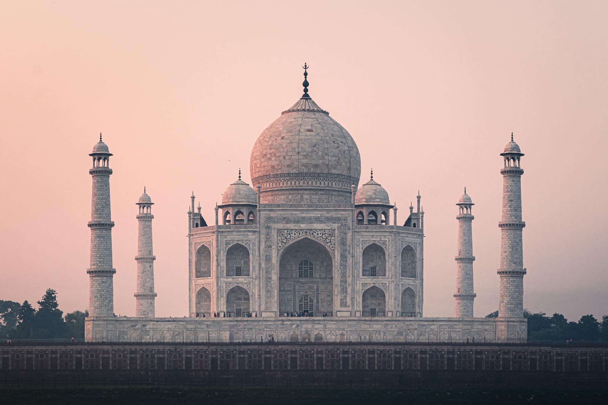 Beautiful view of the Taj Mahal at sunrise, showcasing its stunning architecture and historical significance.