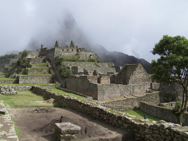 Explore the breathtaking ancient ruins of Machu Picchu shrouded in mist.