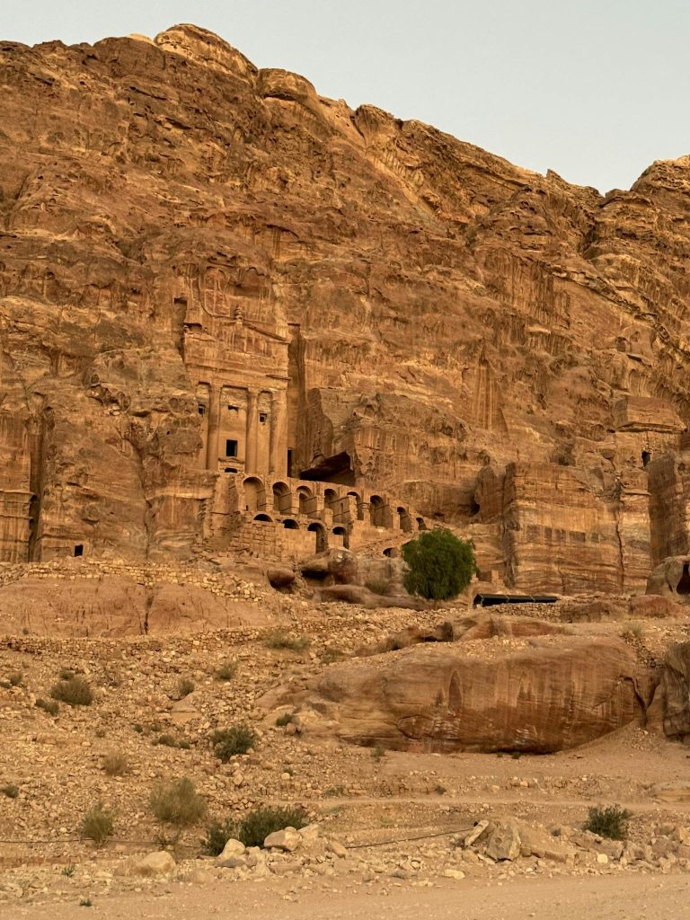 Explore the stunning rock-cut architecture of Petra, Jordan, captured in the golden light of the day.